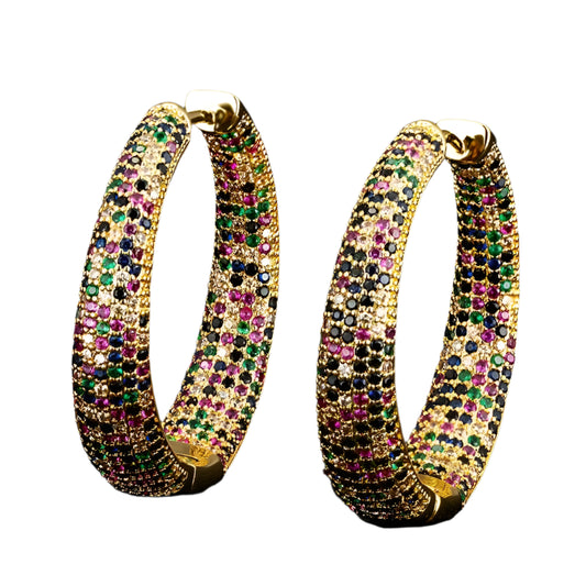 Gold hoop earrings with multicolored gemstones on a black background